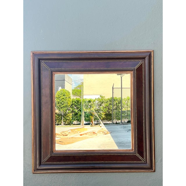 This sophisticated vintage wall mirror offers a refined blend of traditional elegance and architectural detail, making it...