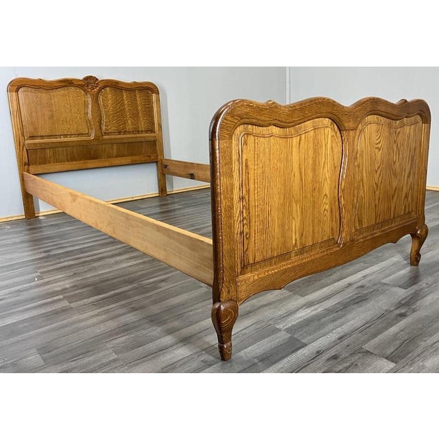 This Vintage French Louis single bed frame presents elegant traditional styling with softly shaped panels and warm oak...