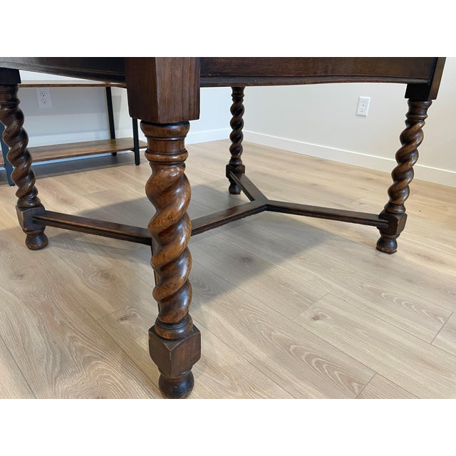 Stunning antique solid oak English pub-style dining table with traditional barley twist legs. This high-quality piece...