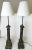 Classic pair of antique French Neoclassical column lamps from the early 1900's. Each is made of metal toleware in a rich...