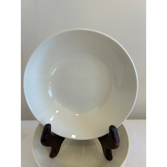 This set of eight vintage white ironstone soup bowls by Johnson Bros of England features a timeless, understated form with...