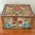 Charming rustic folk art cigar box painted by hand in bright shades of blue, pink, green, and yellow. Surrounded by a...
