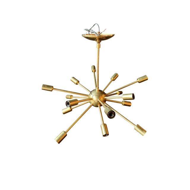A classic Midcentury Sputnik brass chandelier. It consists of 16 arms radiating, each culminating in a single bulb socket....