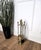 Italian brass four-piece fire tool set with stand. The set consists of a poker, a shovel, a brush and a pair of tongs,...