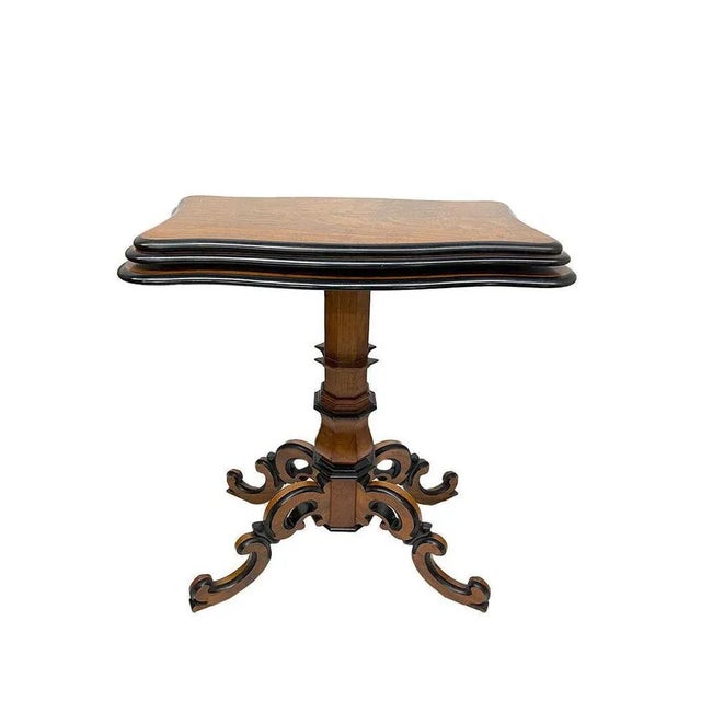 Extendable walnut etagere table 19th century, standing on beautifully decorated triangular frame with scroll legs. Willem...