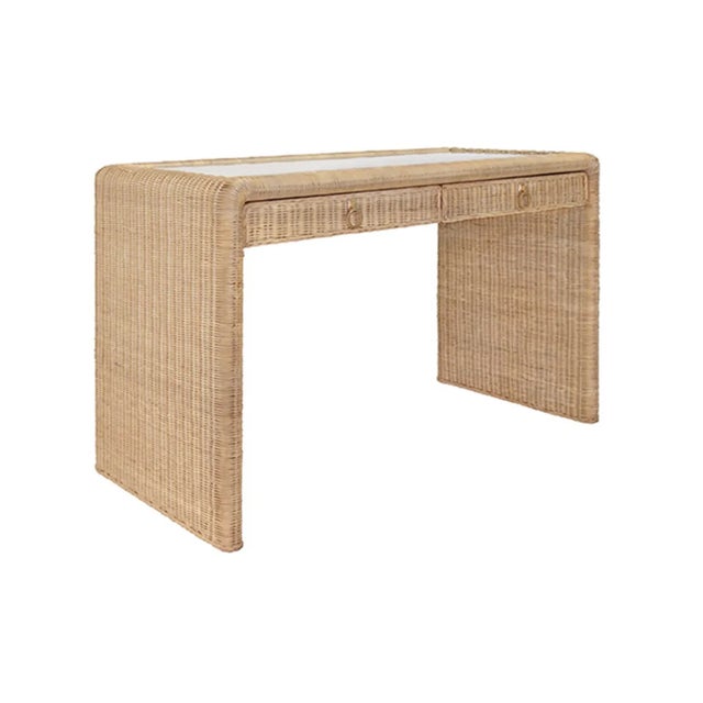 Freshen up your workspace with the coastal Adrien Rattan Waterfall Edge Desk with glass top, featuring a unique woven...
