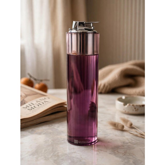 Cylindrical table lighter in amethyst-colored acrylic glass, a masterpiece of 1970s design by renowned Florentine artist...