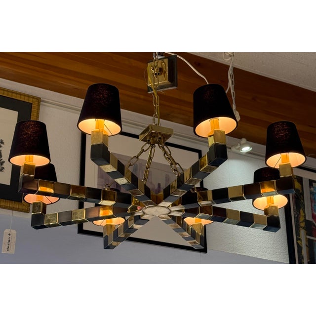 Design Plus Gallery presents an Eight Light Chandelier. The chandelier was originally housed in an elegantly designed...