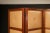 A beautiful four-paneled Brazilian Hardwood folding screen with leather panels on one side and mirrored paneling on the...