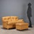 Two-seater sofa with footrest with foam and feather padding and leather upholstery. This piece is attributed to the...