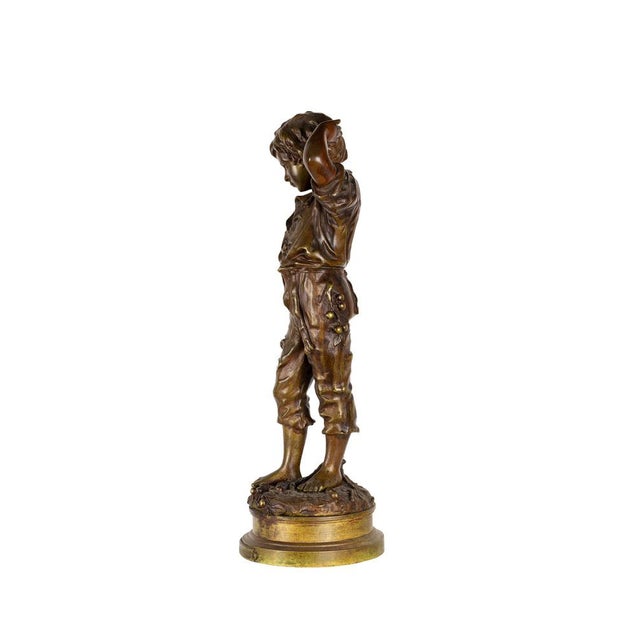 This 19th-century tabletop bronze sculpture titled Un Accident captures a moment of innocent confusion through the...