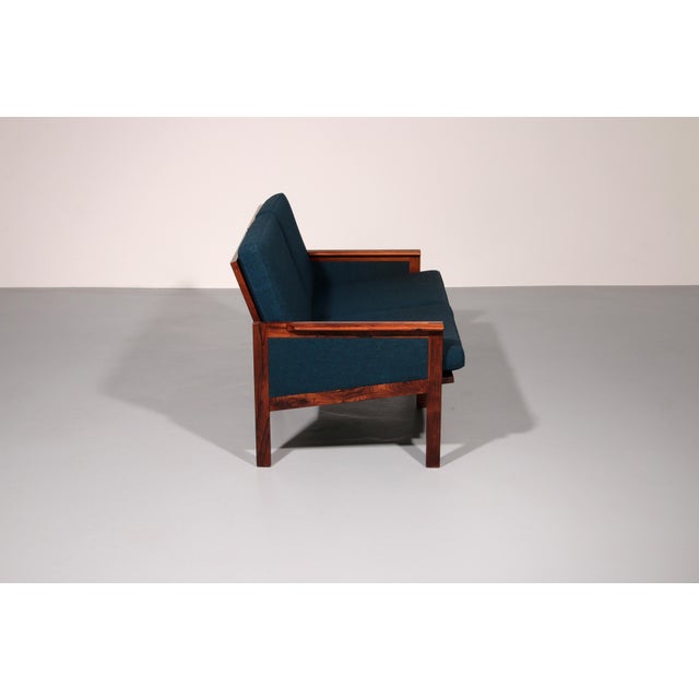 Relive the golden age of Danish design with this bench featuring new cushions in blue fabric from the Capella series,...