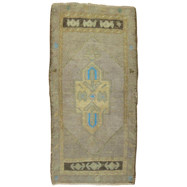 Midcentury Turkish Oushak featuring a pop of electric blue. Measures: 1'9'' x 3'3''.