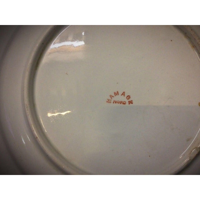 Discover this exquisite antique faience plate from the 20th century or earlier, showcasing the distinctive "Hamage Nord"...