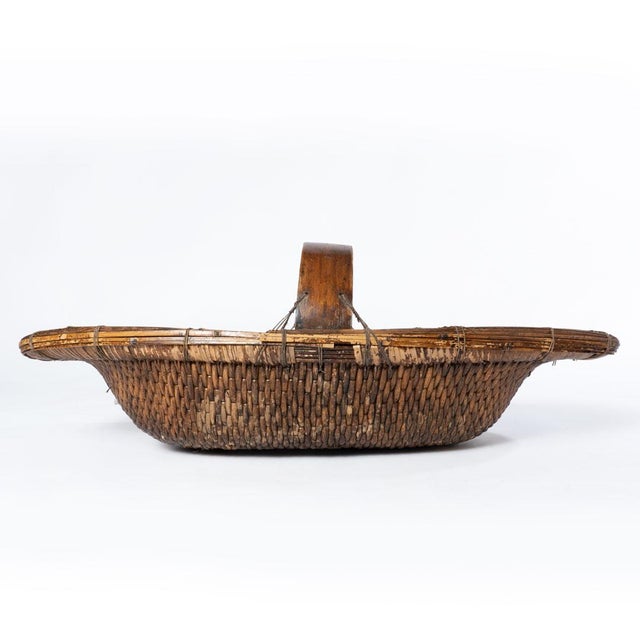 This large stunning antique basket measures 33.5 inches long and 6.5 inches tall without the handle and 15.5 inches wide...