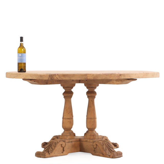 This French round solid oak table, dating to circa 1940, features a substantial thick-plank top allowing its warm,...