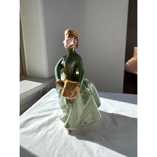 “Grace” (H.N. 2318), introduced by Royal Doulton in 1959, is a finely crafted bone china figurine from the renowned H.N....