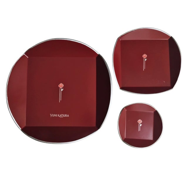 Stunning vintage set of three nesting trays by renowned Japanese designer Yumi Katsura. Each tray features a deep crimson...
