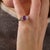 This exceptional vintage ring is centered by a GIA-certified oval cut pinkish purple sapphire weighing 2.65 carats....