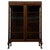 An elegant early 20th-century English display cabinet, finely crafted from oak and distinguished by its extensive glazing,...