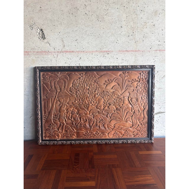 This mid-20th-century Balinese wood relief depicts a traditional village scene centered on figures harvesting rice in...