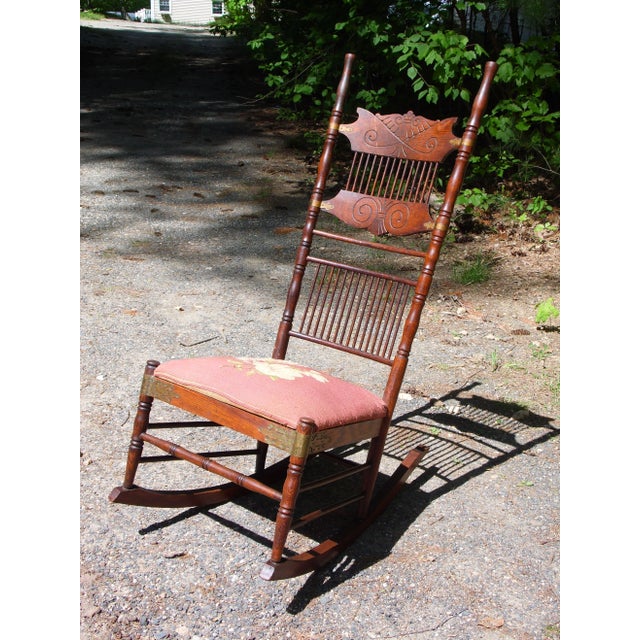 Antique Spoon Carved Solid Oak Spindle Back Rocker Rocking Chair, New England Circa 1900. Features decorative brass straps...