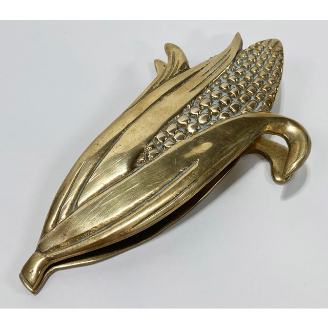Large vintage brass clip featuring corn cob form. Great desk addition to contain papers and receipts. Wonderful patina....