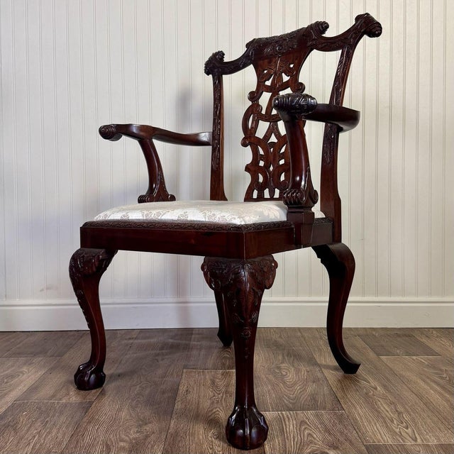 Beautiful carved armchair with ball-and-claw feet, an intricately carved pierced splat with a ribbon and tassel motif, a...