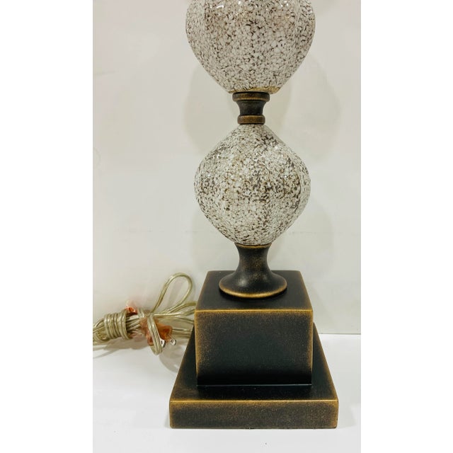 Stylish Urey & Company Modern Cream Glazed Abstract Table Lamp, bronze and gold finished metal base, showroom floor sample