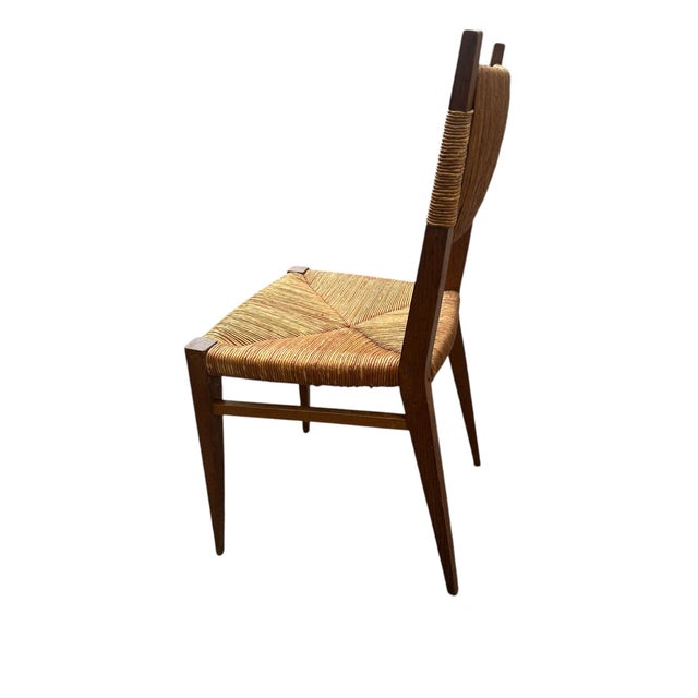 Oak chairs with original straw seat and back in modernist design from the 1950s This piece is designed in the style of the...