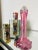 This is not your grandma’s cranberry glass bud vase. This early 20th-century handblown glass piece features a striking,...