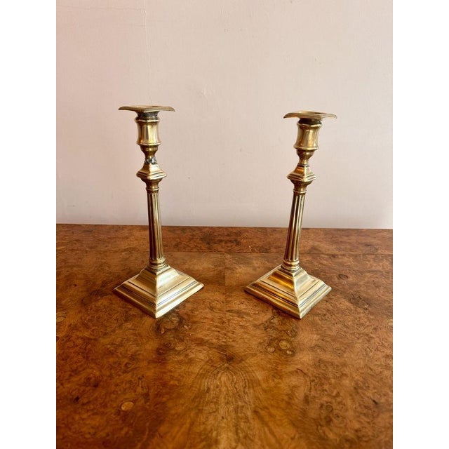 Quality pair of antique Regency brass candlesticks, having a quality pair of antique Regency brass candlesticks with...