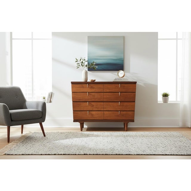 This beautifully restored Mid-Century Modern walnut chest of drawers is a timeless example of clean architectural design...
