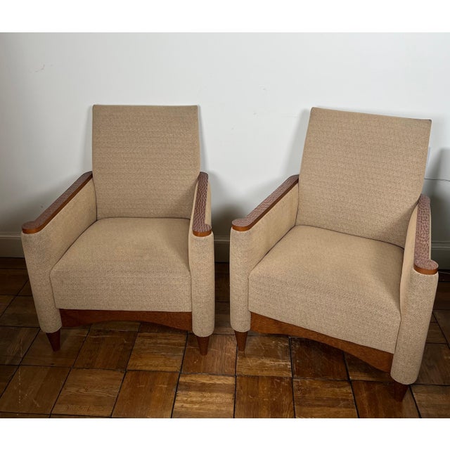 This beautiful and elegant pair of armchairs is made of gouged wood and mottled fabric. It is a French work in the Art...