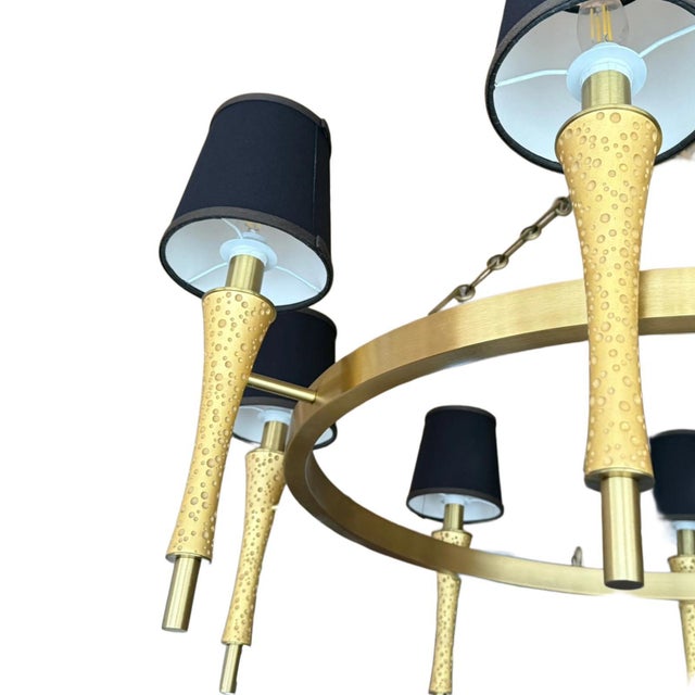 Prosecco 8-Arm chandelier by Jamie Drake for Boyd Lighting, executed in a satin brass finish and suspended from a...