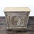 This wooden cabinet features a rustic finish and a unique oval design on the front doors. It includes a top tray surface...