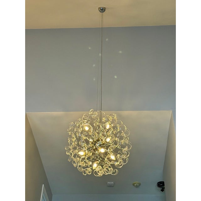 Bring sculptural drama and modern Venetian artistry into your space with this Uplight Group Astro P85 Chandelier, a...