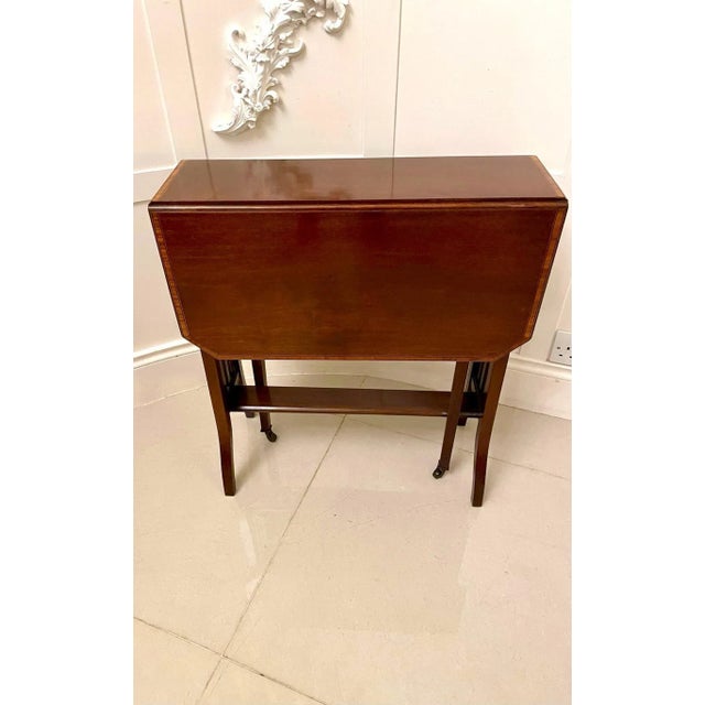 Antique Edwardian quality mahogany inlaid Sutherland table having a quality mahogany drop leaf satinwood crossbanded top,...