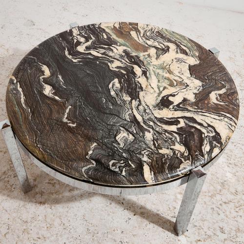 Round shaped coffee table with chrome legs and heavy stone top from the 1970s. with some surface scratches and wear on the...