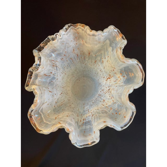 Exquisite handkerchief vase in the style of Murano glass. Waves of milky white glass are accented with gold specks and a...