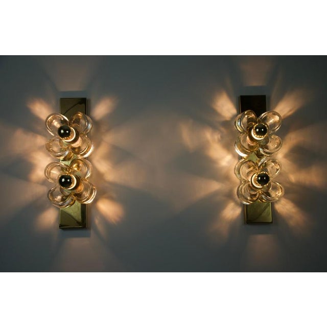 This stylish pair of wall lamps from 1960s germany captures the essence of mid-century modern design with their bold...
