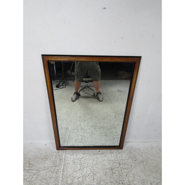 Mid-Century Modern Style wall mirror. Rosewood frame with a black trim. Dimensions: 34w, 1d, 48h Condition: age...