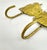 A sculptural pair of vintage brass wall hooks designed as stylized fish, featuring textured surfaces and a warm, naturally...