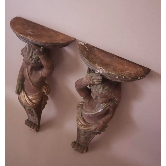 Antique wood carved caryatids. Accented with brushed gold and hints of light green over warm rusty wood tones. Each figure...