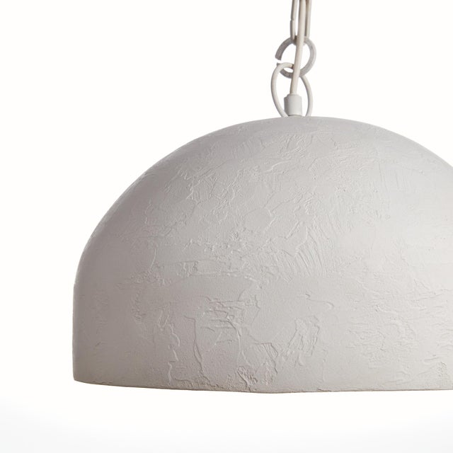 A modern statementworthy pendant with a lightly pounded textured metal dome shade. Finished in an ontrend matteWhite, this...