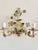 Pair of vintage floral tole wall sconces in painted metal, with colorful flowers and green foliage arranged above ribbed...