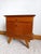Pair of vintage wooden bedside tables, circa 1960, with black glass tops (the tops are fixed). Each table features a...