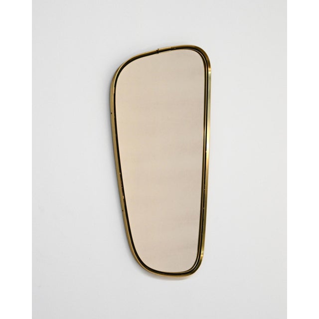 Wall mirror with brass frame. European production, 1950s. European production from the 1950s, attributable to the...