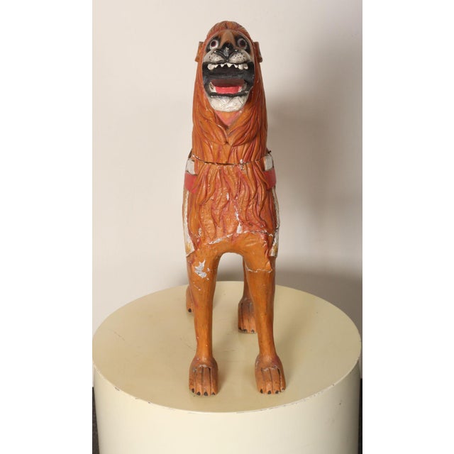Folk art hand-carved and painted standing lion in solid pine (ca. Mid-20th Century, Texas, USA). Given its stature and...