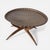 A striking mid century teak and brass coffee table, featuring an elegant spider-leg base and a sculptural circular form....